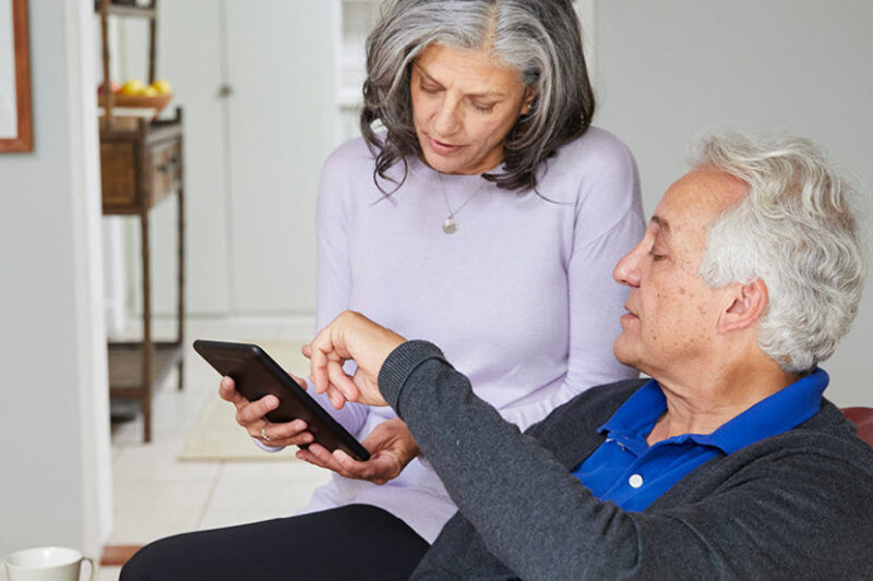 Couple reviewing dating insurance plan on laptop"