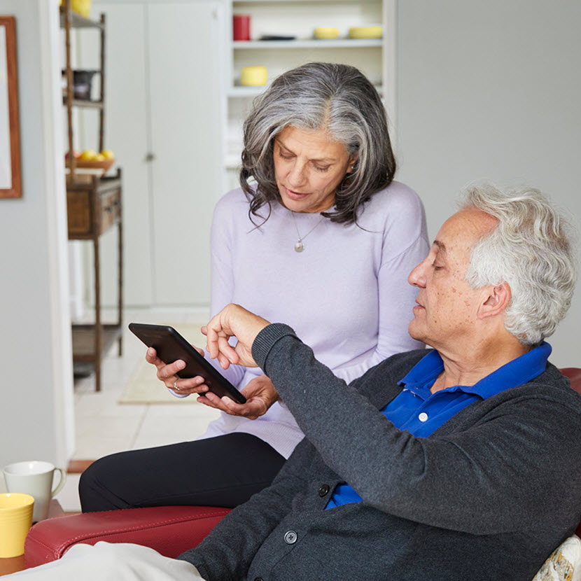 Couple reviewing dating insurance plan on laptop"